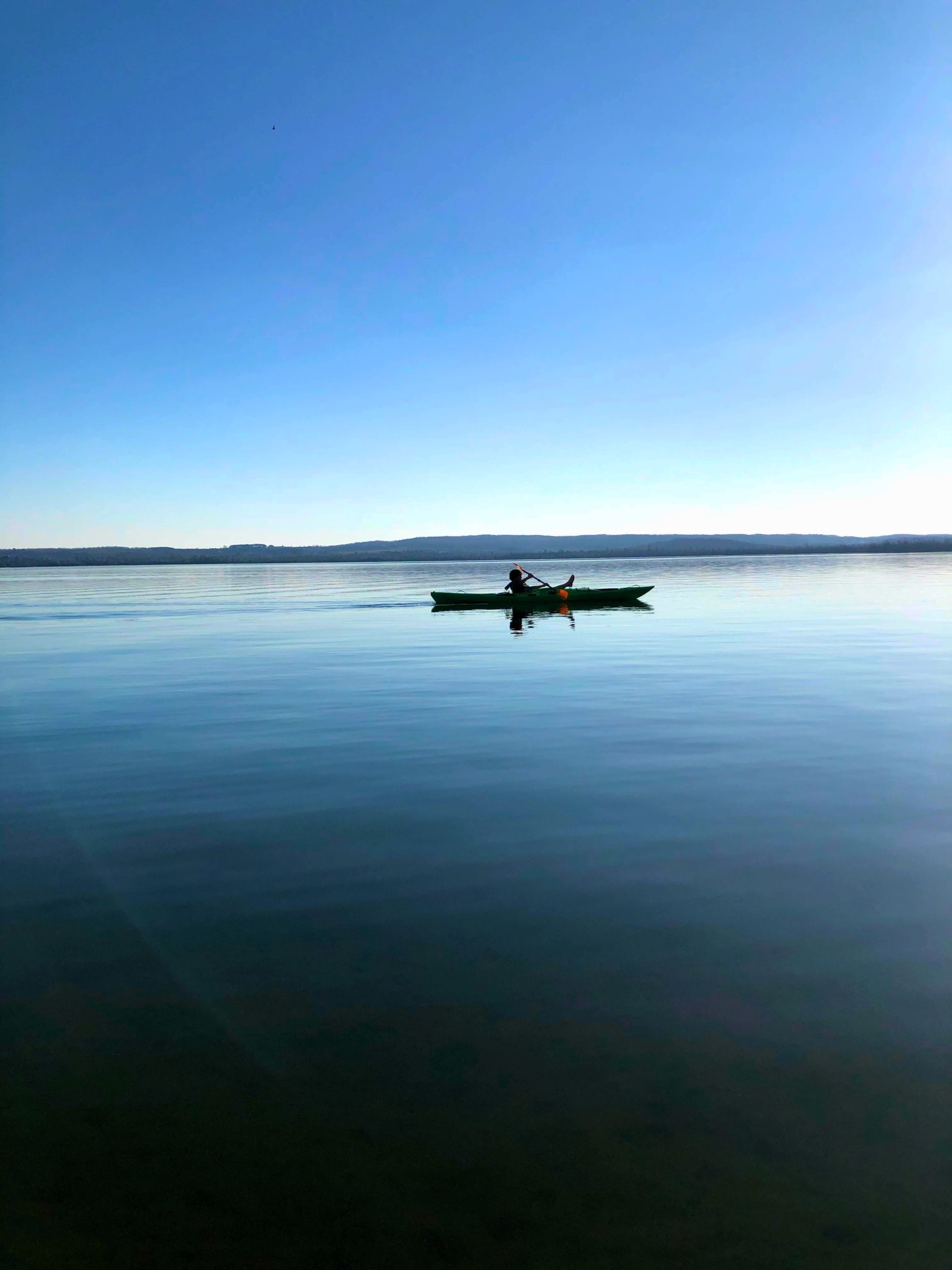 person kayaking in the lake
